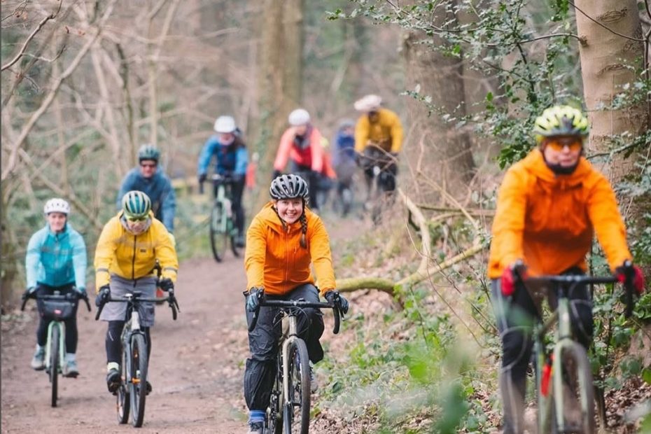 Smiling people riding on an outside bike path. Text reads Saturday 15 November 9am-2pm
